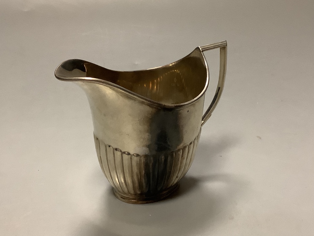 An Edwardian demi fluted silver cream jug, William Hutton & Sons, Sheffield, 1908, 9cm